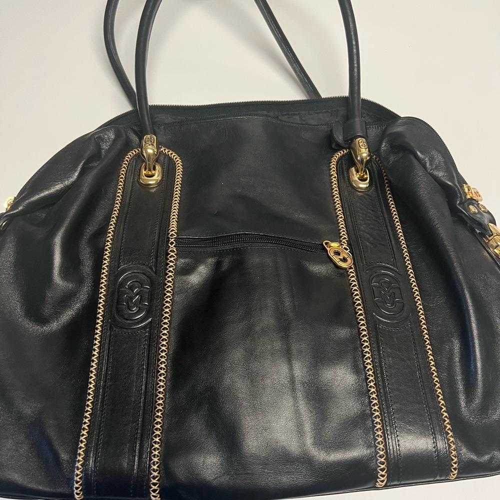 large leather bag with gold hardware